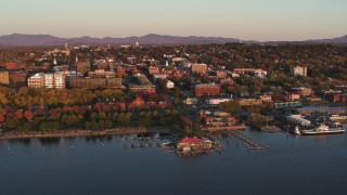 DX0002_225_013 - 5.7K aerial stock footage orbit buildings and park in downtown behind marinas at sunset, Burlington, Vermont