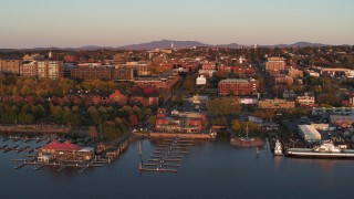 DX0002_225_015 - 5.7K aerial stock footage fly over marina toward downtown at sunset, Burlington, Vermont