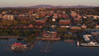 DX0002_225_016 - 5.7K aerial stock footage fly away from downtown and a marina at sunset, Burlington, Vermont