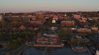DX0002_225_019 - 5.7K aerial stock footage a view of downtown at sunset, descend to reveal marina, Burlington, Vermont