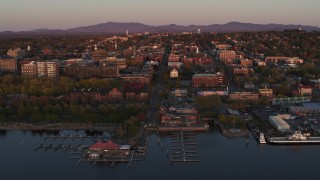 DX0002_225_020 - 5.7K aerial stock footage ascend away from downtown and marina at sunset, Burlington, Vermont