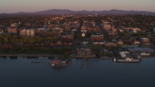 DX0002_225_021 - 5.7K aerial stock footage circling downtown and two marinas at sunset, Burlington, Vermont