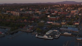 DX0002_225_022 - 5.7K aerial stock footage an orbit around downtown and two marinas at sunset, Burlington, Vermont