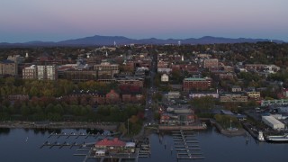 DX0002_225_030 - 5.7K aerial stock footage approach and flyby downtown buildings and a marina at twilight, Burlington, Vermont