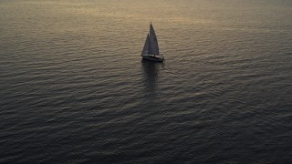 DX0002_225_034 - 5.7K aerial stock footage approach and orbit sailboat on Lake Champlain at twilight, Burlington, Vermont