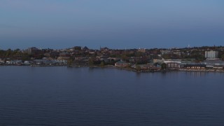 DX0002_225_037 - 5.7K stock footage aerial video slowly approach downtown buildings from the lake at twilight, Burlington, Vermont