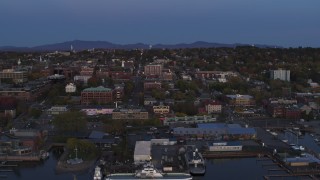 DX0002_225_039 - 5.7K aerial stock footage of orbiting downtown and marina at twilight, Burlington, Vermont