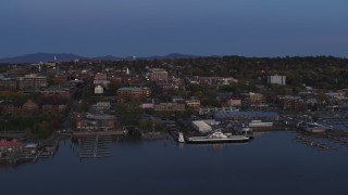 DX0002_225_040 - 5.7K aerial stock footage of orbiting downtown and the lakeside marinas at twilight, Burlington, Vermont