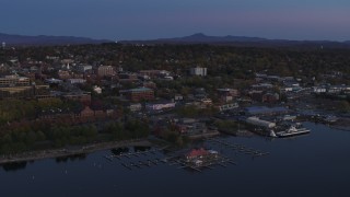 DX0002_225_041 - 5.7K aerial stock footage of an orbit of downtown and the lakeside marinas at twilight, Burlington, Vermont