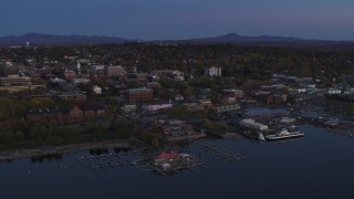 DX0002_225_043 - 5.7K aerial stock footage of an orbit around downtown and the lakeside marinas at twilight, Burlington, Vermont