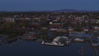 DX0002_225_044 - 5.7K aerial stock footage circling around downtown area and the lakeside marinas at twilight, Burlington, Vermont