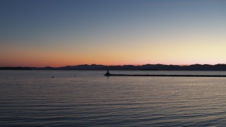 DX0002_226_001 - 5.7K aerial stock footage of flying low toward lighthouse on Lake Champlain at twilight, Burlington, Vermont