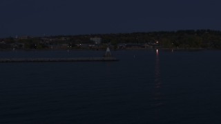 DX0002_226_007 - 5.7K aerial stock footage of orbiting around a Lake Champlain lighthouse at night, Burlington, Vermont