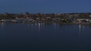 DX0002_226_009 - 5.7K aerial stock footage slowly approaching the downtown area at twilight, seen from the lake, Burlington, Vermont