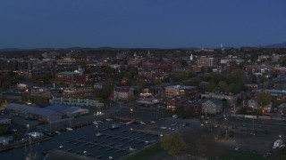DX0002_226_010 - 5.7K stock footage aerial video slowly approaching downtown area office buildings at twilight, Burlington, Vermont