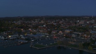 DX0002_226_014 - 5.7K aerial stock footage reverse view of city's downtown area at twilight, reveal marina, Burlington, Vermont