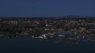 DX0002_226_015 - 5.7K stock footage aerial video a wide orbit of city's downtown area and marinas at twilight, Burlington, Vermont