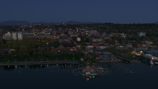 DX0002_226_016 - 5.7K aerial stock footage of city's downtown area and a marina at twilight, Burlington, Vermont