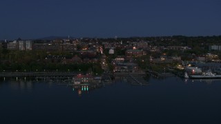 DX0002_226_017 - 5.7K aerial stock footage of a slow orbit of city's downtown area and marinas at night, Burlington, Vermont