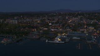 DX0002_226_018 - 5.7K aerial stock footage ascend and orbit city's downtown area and marinas at night, Burlington, Vermont
