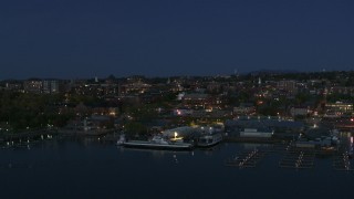 DX0002_226_021 - 5.7K aerial stock footage fly away from the city's downtown area and a marina at night, Burlington, Vermont