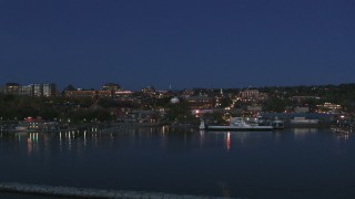 DX0002_226_022 - 5.7K aerial stock footage fly low toward the city's downtown area and over a marina at night, Burlington, Vermont
