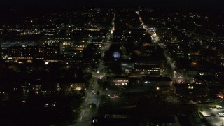 DX0002_226_036 - 5.7K aerial stock footage orbit office buildings around College Street lit up for nighttime, Burlington, Vermont