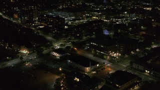 DX0002_226_037 - 5.7K aerial stock footage orbit office buildings on Battery Street lit up for nighttime, Burlington, Vermont