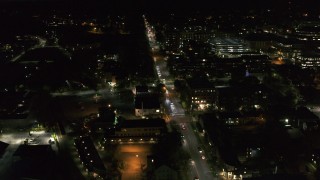 DX0002_226_038 - 5.7K aerial stock footage circling and flying away from office buildings on Battery Street lit up for nighttime, Burlington, Vermont