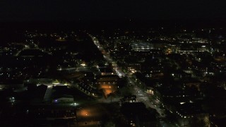 DX0002_226_039 - 5.7K aerial stock footage of an orbit of office buildings on Battery Street lit up for nighttime, Burlington, Vermont