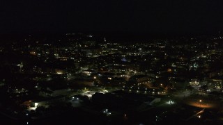 DX0002_226_040 - 5.7K aerial stock footage of slowly orbiting office buildings in downtown lit up for nighttime, Burlington, Vermont