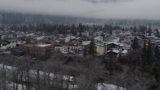 DX0002_227_008 - 5.7K aerial stock footage ascend from trees to reveal the small town, Leavenworth, Washington
