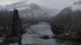 DX0002_227_013 - 5.7K aerial stock footage of following the river toward snowy mountains in Leavenworth, Washington