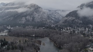 DX0002_227_016 - 5.7K aerial stock footage follow the river toward Leavenworth, Washington and snowy mountains