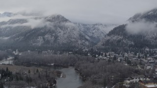 DX0002_227_020 - 5.7K aerial stock footage of flying by Leavenworth and snowy mountains, Washington