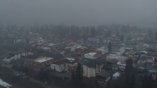 DX0002_227_022 - 5.7K aerial stock footage of orbiting Christmas trees as it snows, Leavenworth, Washington
