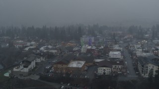 DX0002_227_023 - 5.7K aerial stock footage of circling Christmas trees as it snows, Leavenworth, Washington