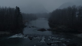 DX0002_227_027 - 5.7K aerial stock footage reverse view of the river during light snowfall, Leavenworth, Washington
