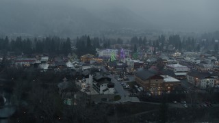 DX0002_227_029 - 5.7K aerial stock footage of orbiting the town with Christmas trees, Leavenworth, Washington