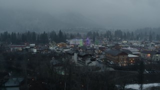 DX0002_227_030 - 5.7K aerial stock footage of tall Christmas trees in the center of town, Leavenworth, Washington