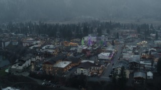 DX0002_227_031 - 5.7K aerial stock footage of an orbit of tall Christmas trees in the center of town, Leavenworth, Washington