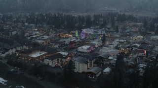 DX0002_227_039 - 5.7K aerial stock footage of circling town while focused on tall Christmas trees, Leavenworth, Washington