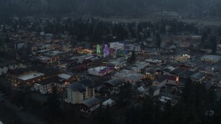 DX0002_227_048 - 5.7K aerial stock footage approaching a small town decorated with Christmas trees and lights, Leavenworth, Washington