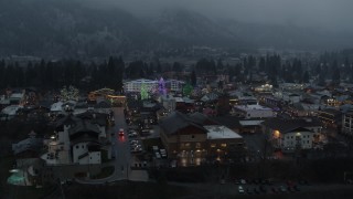 DX0002_227_051 - 5.7K aerial stock footage orbiting a small town decorated with Christmas trees and lights, Leavenworth, Washington