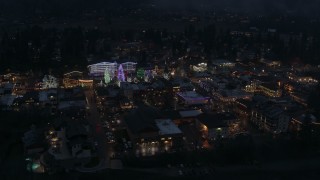 DX0002_228_010 - 5.7K aerial stock footage of flying around Christmas trees and lights at night in Leavenworth, Washington
