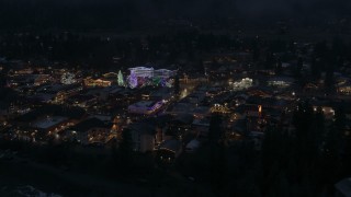 DX0002_228_011 - 5.7K aerial stock footage orbit and fly away from Christmas trees and lights at night in Leavenworth, Washington