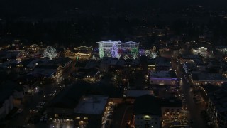 DX0002_228_018 - 5.7K aerial stock footage of Christmas trees and lights at night in Leavenworth, Washington