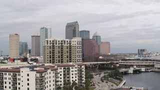 DX0003_229_004 - 5.7K aerial stock footage fly away from tall skyscrapers, descend by apartments in Downtown Tampa, Florida
