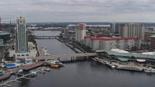 DX0003_229_028 - 5.7K aerial stock footage reverse view of condo complexes by a channel in Tampa, Florida