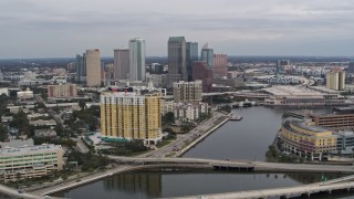 DX0003_229_044 - 5.7K aerial stock footage of flying over bridges and channel while focused on skyline, Downtown Tampa, Florida